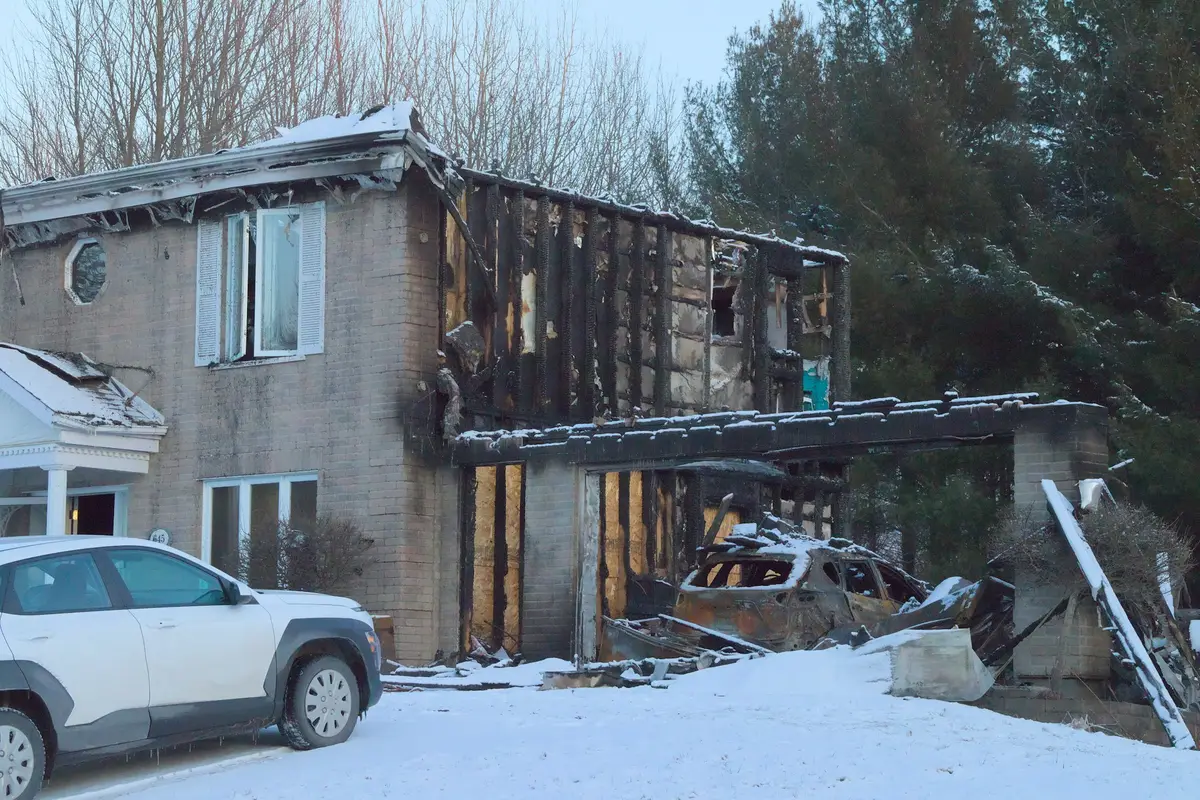A two story house with fire damage to its upper floor