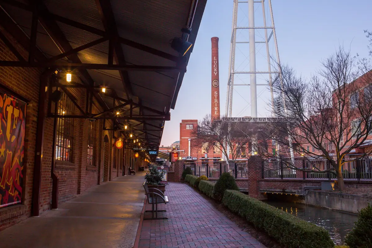 Brick tobacco warehouses, a covered walkway and a water tower in Durham